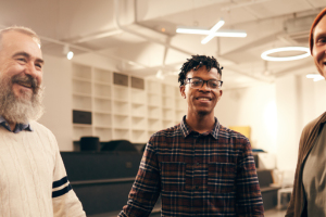 Three men smiling.