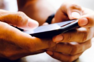 Closeup Image of man's hand holding a smartphone